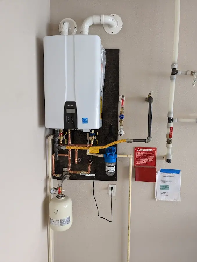 Professional plumber installing copper piping in a East Goshen home